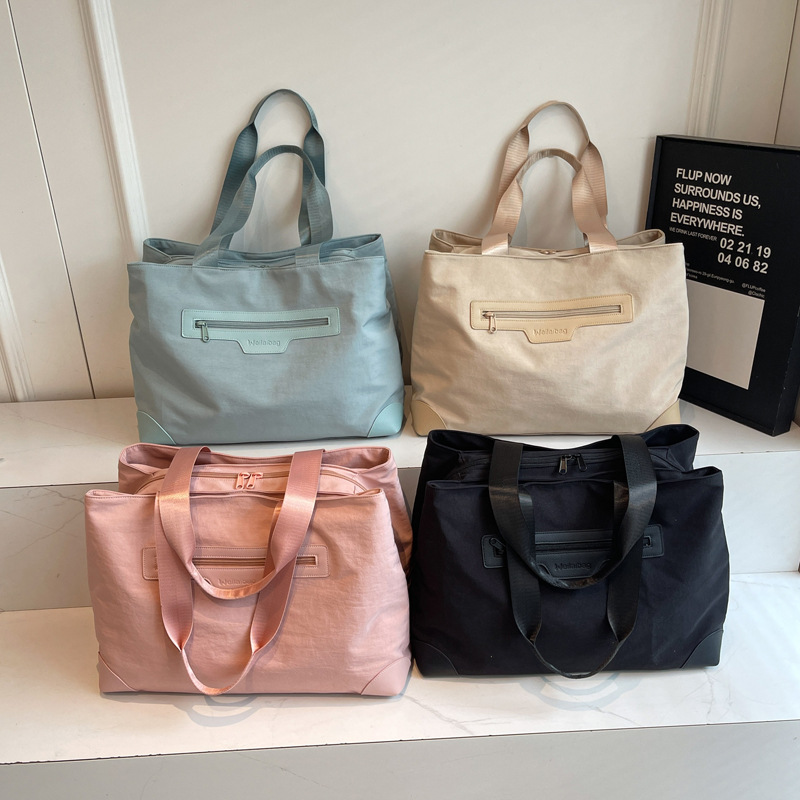 Nuevo tipo de tela casuales de mujer de hombro bolsa de viaje corto de gran capacidad de color sólido bolsa de equipaje ligero de mujer