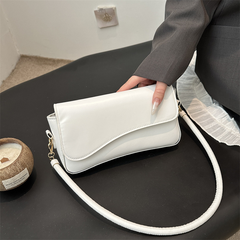 Bolso debajo de la axila para mujeres 2025 primavera nueva moda de alta sensación de hombro mochila de nicho bolso de textura cuadrada