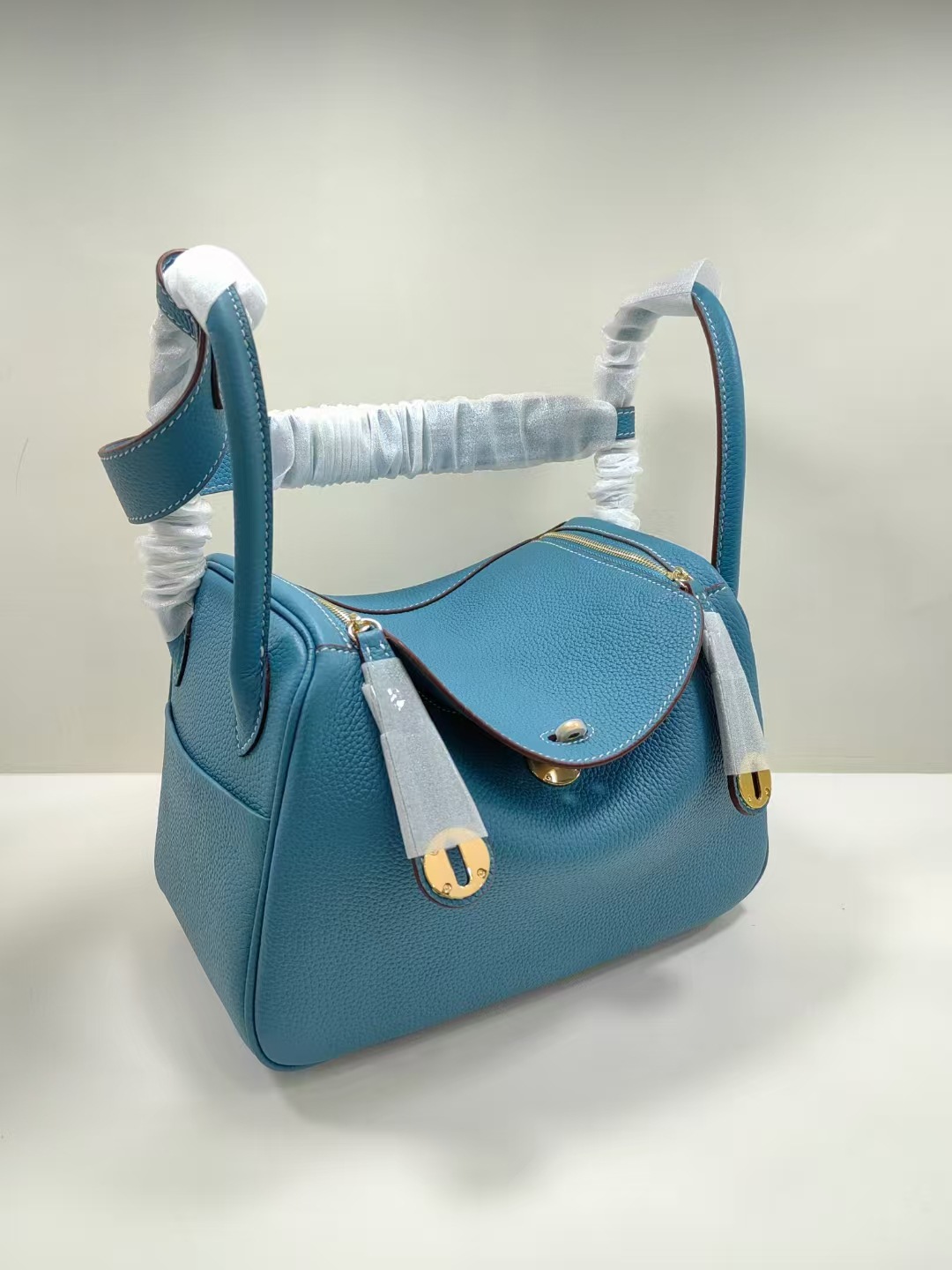 Bolsos de cuero Lindy de piel de vaca con togo de primera capa 2025 Bolsos de cubo retro de estilo europeo y americano Bolsos portátiles de moda