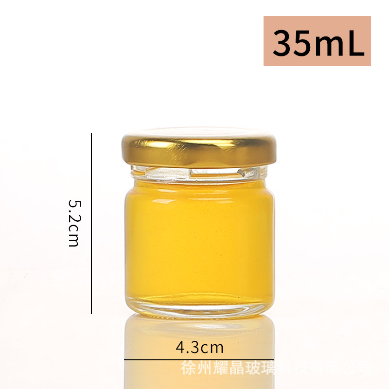 Botella de vidrio redonda de grado alimenticio, botella enlatada transparente sellada, botella de salsa de chile vacía, botella de miel con tapa para cocinar