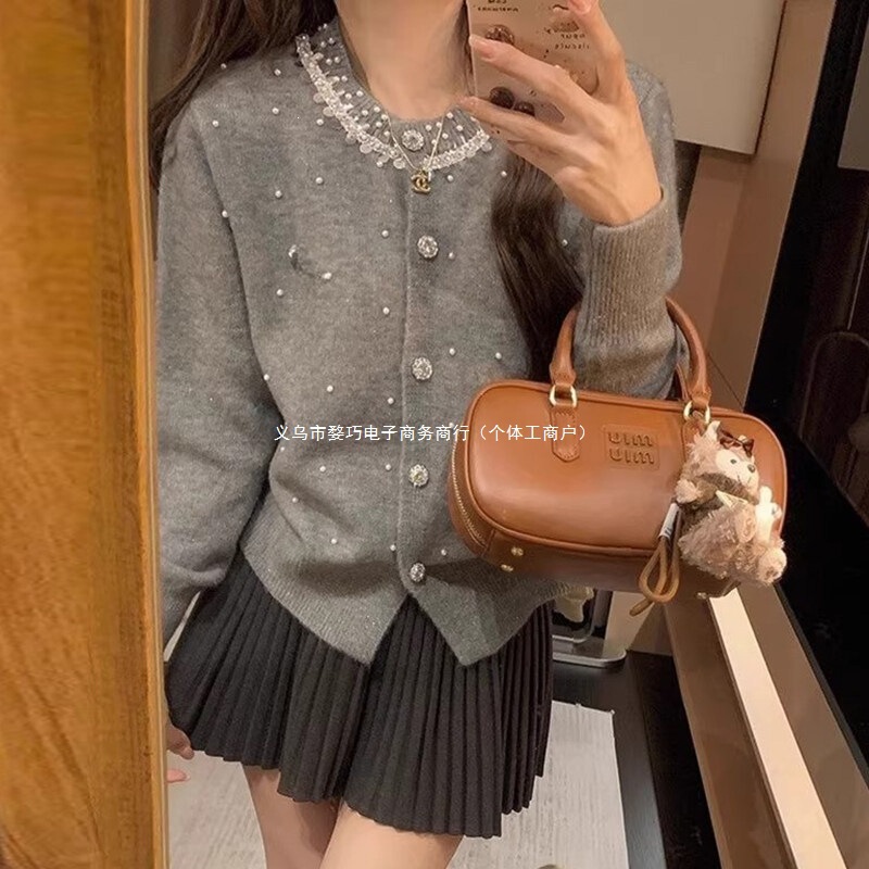 Korean-style, soft gray pearl lace-trimmed knit cardigan with delicate, shimmering bead embellishments, creating a chic, Chanel-inspired sweater Korean-style, soft gray pearl lace-trimmed knit cardigan with delicate, shimmering bead embellishments, creating a chic, Chanel-inspired sweater