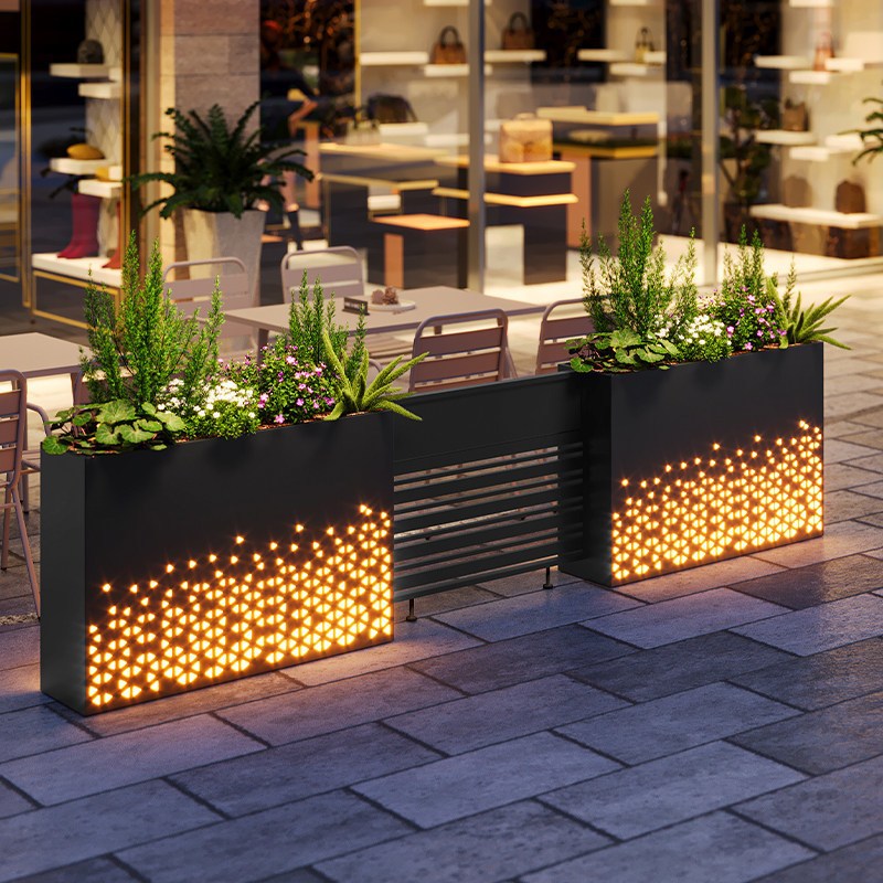 Outdoor shop with illuminated creative design, metal fence partition, storefront display, and wrought iron flower box