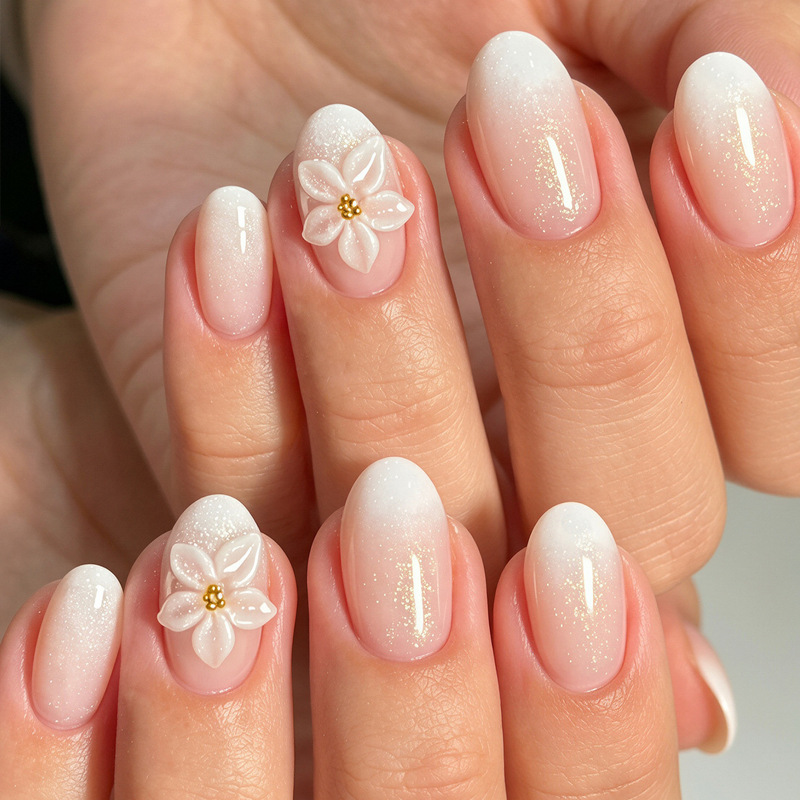 Simple, gentle, and elegant style with white gradient design, three-dimensional rubberized flowers, small gold beads, and a refined, brightening effect on the nails Simple, gentle, and elegant style with white gradient design, three-dimensional rubberized flowers, small gold beads, and a refined, brightening effect on the nails