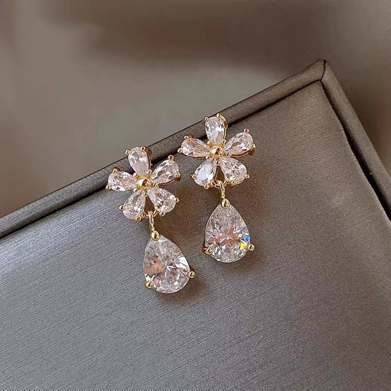 Elegant small design earrings drop-shaped with zircon