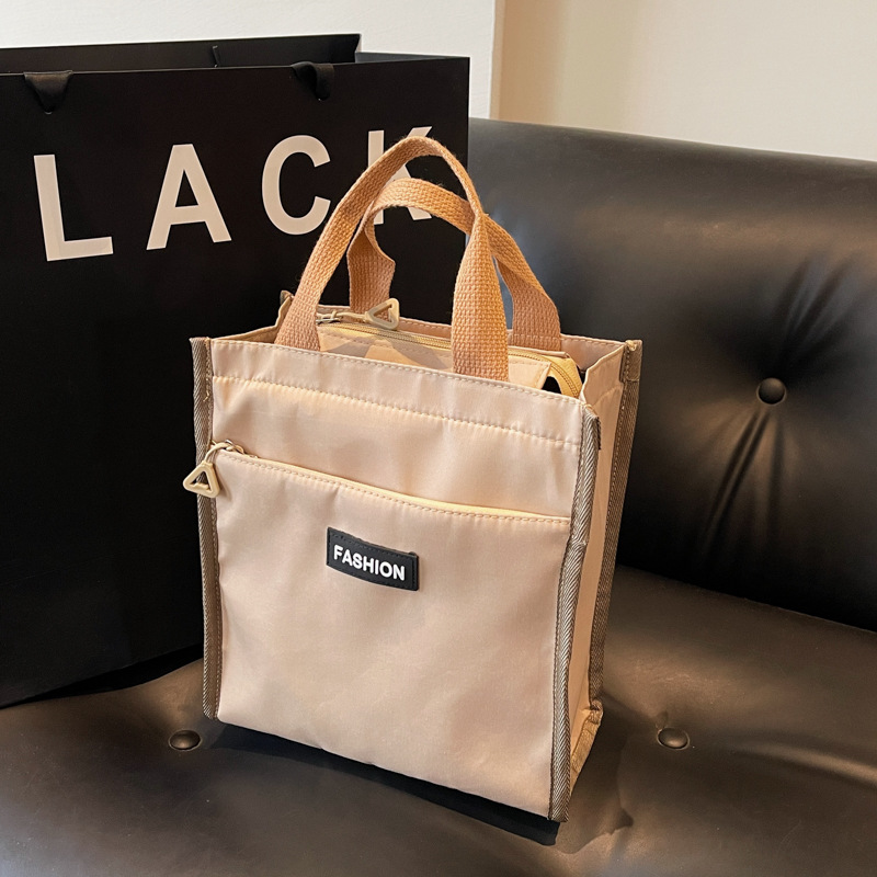 Moda coreana nueva serie de gran capacidad bolsas escolares portátiles de otoño 2024 bolsas de botellas impermeables Oxford