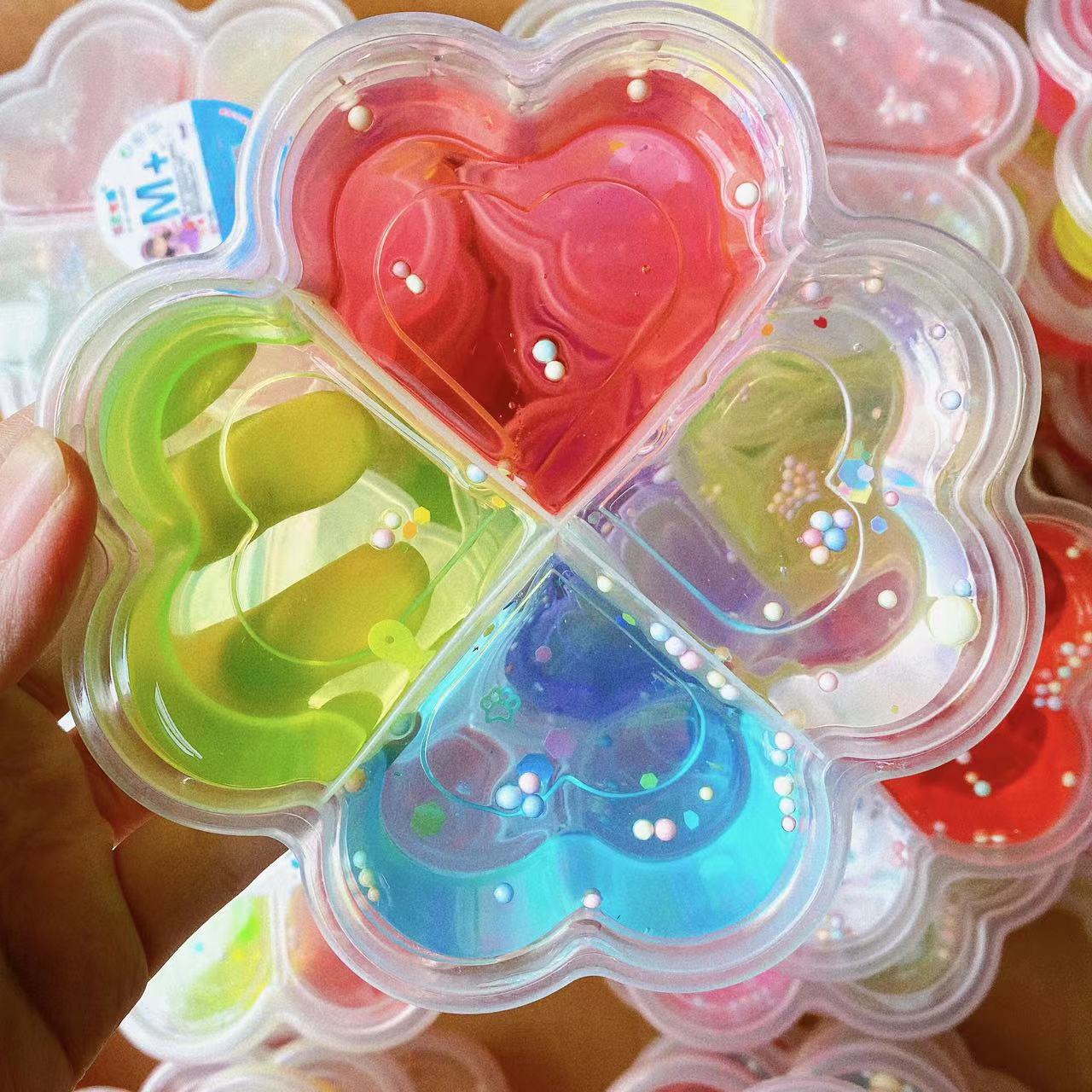 Nueva melocotón en forma de corazón de cristal de barro Trébol de alta permeabilidad pegamento espumante 4 Rejilla 4 Color de descompresión DIY Delgado fábrica al por mayor