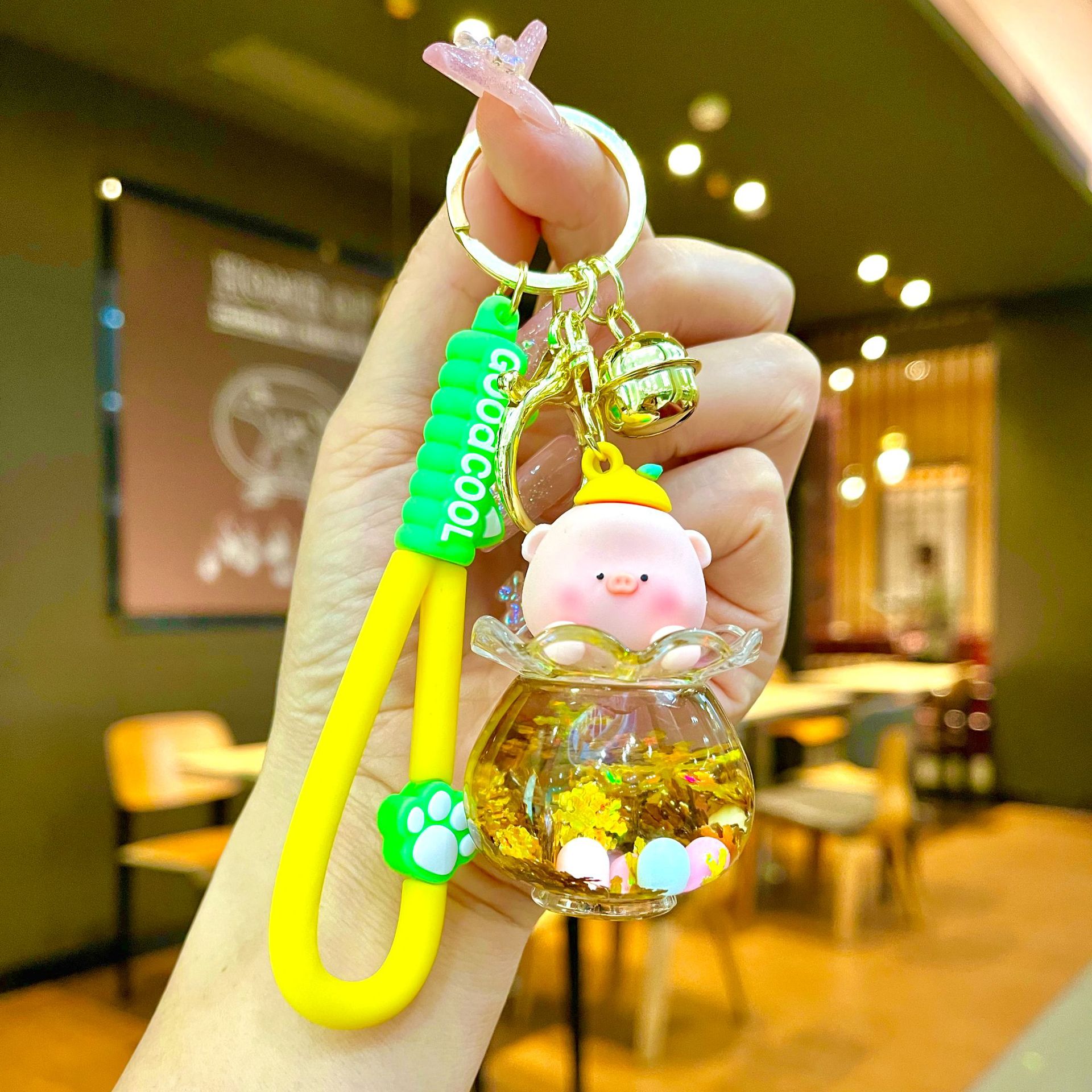 Aceite de gato garra arenas movedizas llavero lindo dibujos animados cadena colgante captura muñeca máquina agarrar pequeño regalo al por mayor