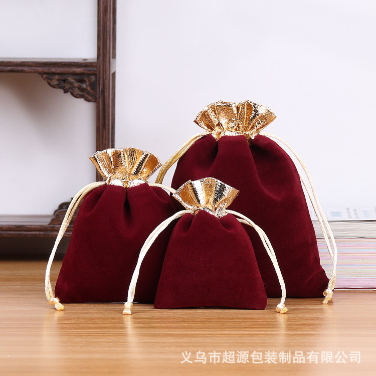 Boca de oro bolsa de terciopelo rojo vino
