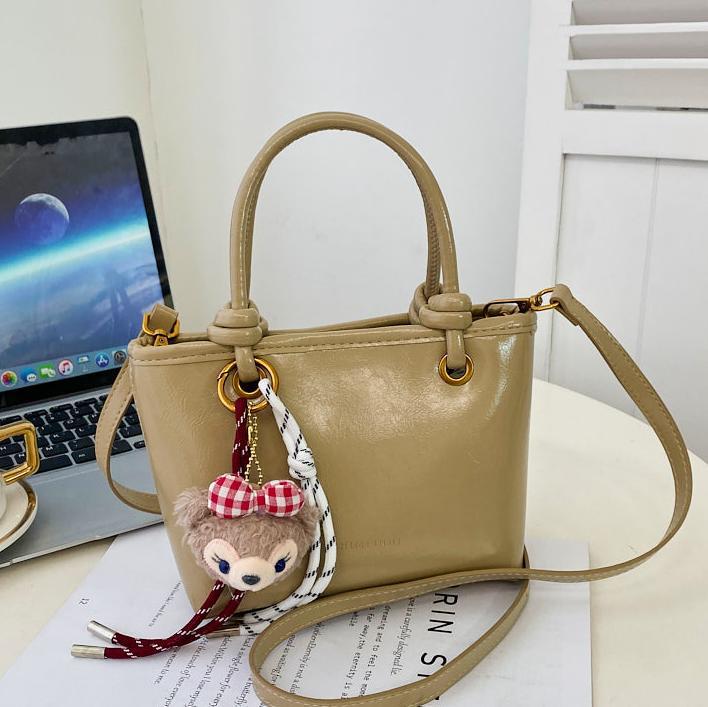 Super caliente versátil bolso de cubo portátil 2025 nuevo popular simple mochila de hombro en línea tendencia explosiva bolso de mujer