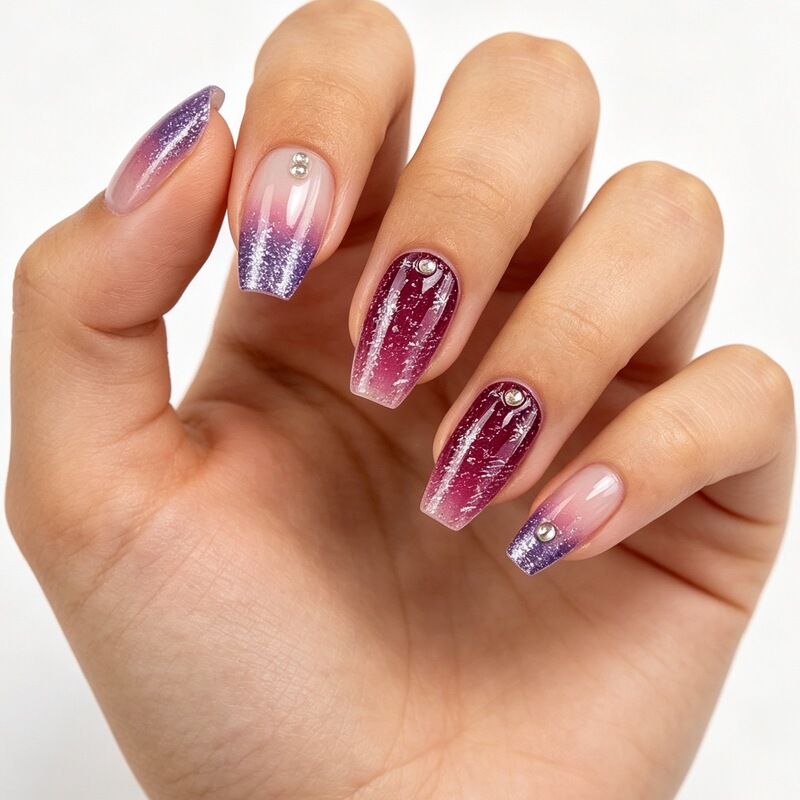 Elegant and delicate nail tips with a sheer base, purple glitter gradient, and burgundy fine glitter embellished with crushed diamonds, wearable nail art