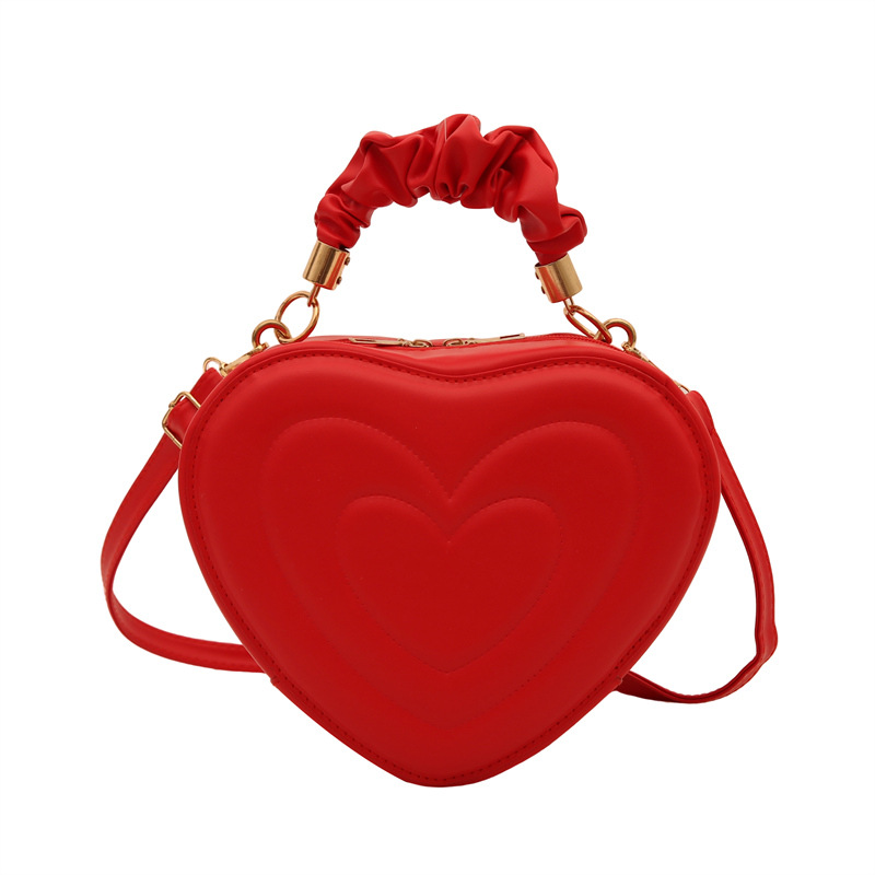 2024 otoño y invierno de mujeres nuevas caramelo de cáscara dura bolso de hombro de color corazón bolso de moda bolso de amor amor amor impresión