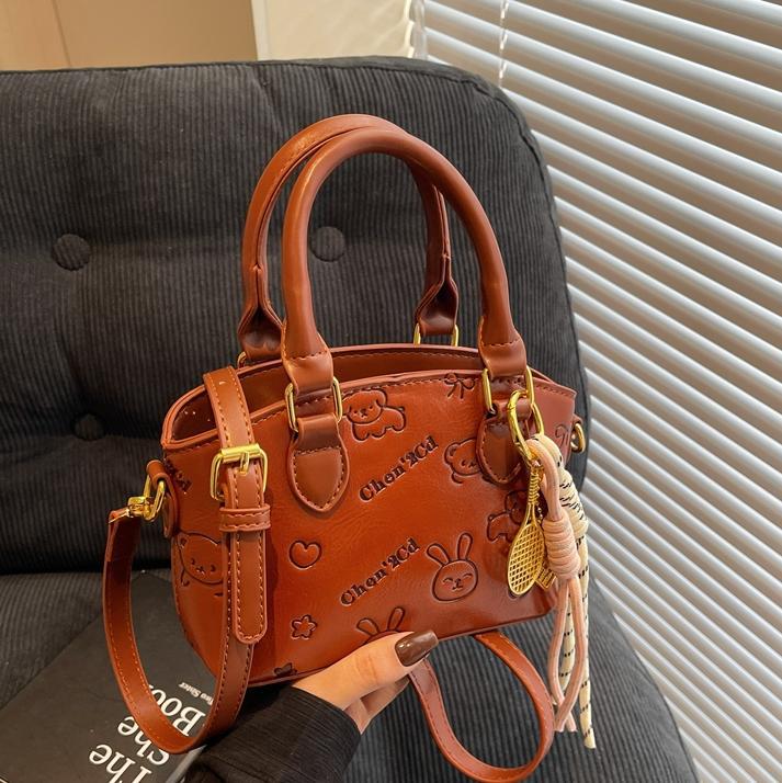 Tendencia nicho bolso de mano de moda mujer 2025 nueva textura versátil bolso de cubo bolso de transporte aéreo