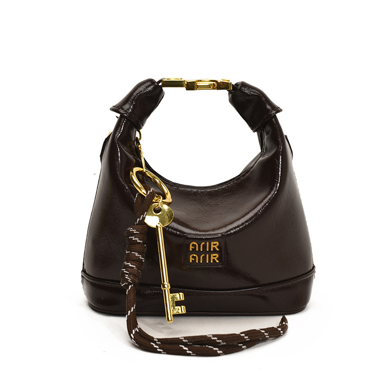 Bolso de hombro para niña coreana bolso de bebé con bloqueo de cuero de aceite de color sólido simple 2025 nuevo mini bolso para niños