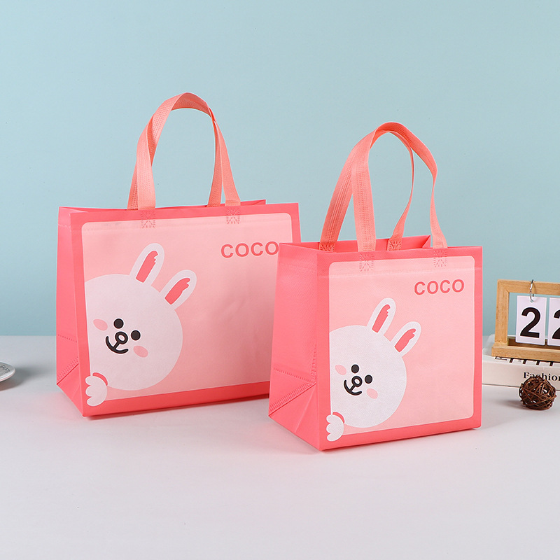 Bolsas de mano no tejidas al por mayor bolsas de embalaje estereoscópicas resistentes al desgaste bolsas de embalaje de dormitorios de estudiantes bolsas de mano en stock