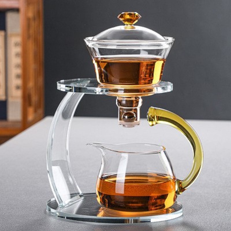 Fábrica al por mayor de vidrio resistente al calor taza de té perezoso traje hogar Kung Fu juego de té engrosada tetera de succión magnética Fabricación de té automática