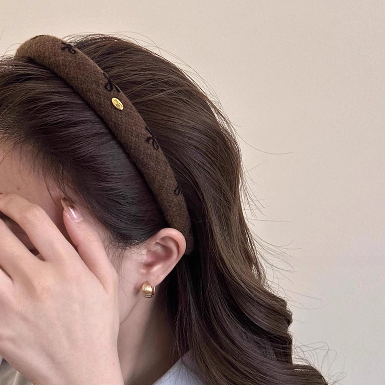 Dark brown headband with black bow