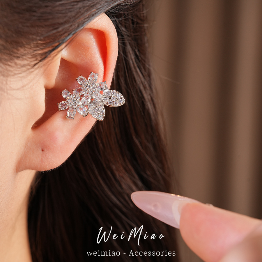 Zircon arco flores orejas clips de orejas mujeres sin agujeros de orejas personalidad temperamento nicho pendientes ligero lujo alta sensación auriculares al por mayor