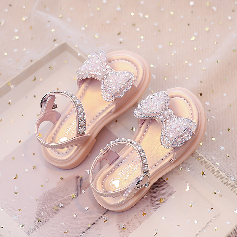 Niños verano 2026 nuevas sandalias de niñas arco brillante con base suave princesa sandalias de viento para niñas sandalias