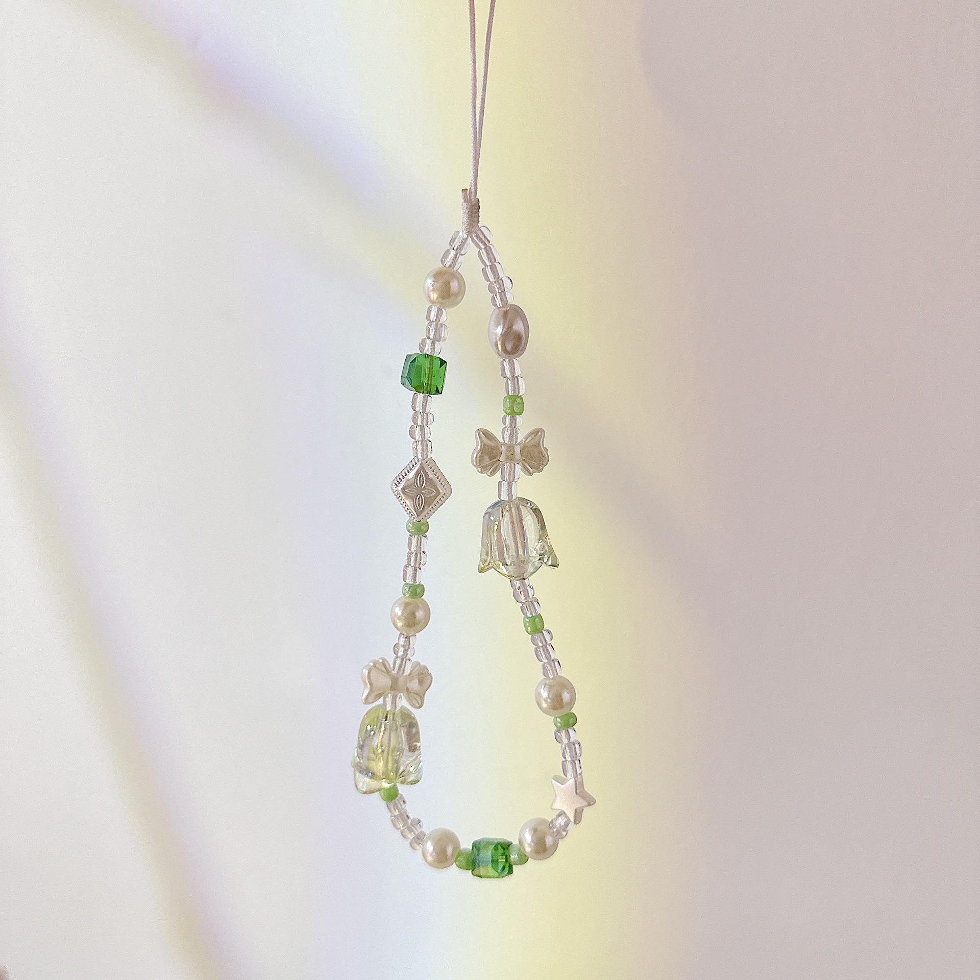 Aplicable cadena coreana orquídea de campana cadena de muñeca arco cuentas de caso de teléfono móvil colgante anti-perdida colgar pulsera trenzada