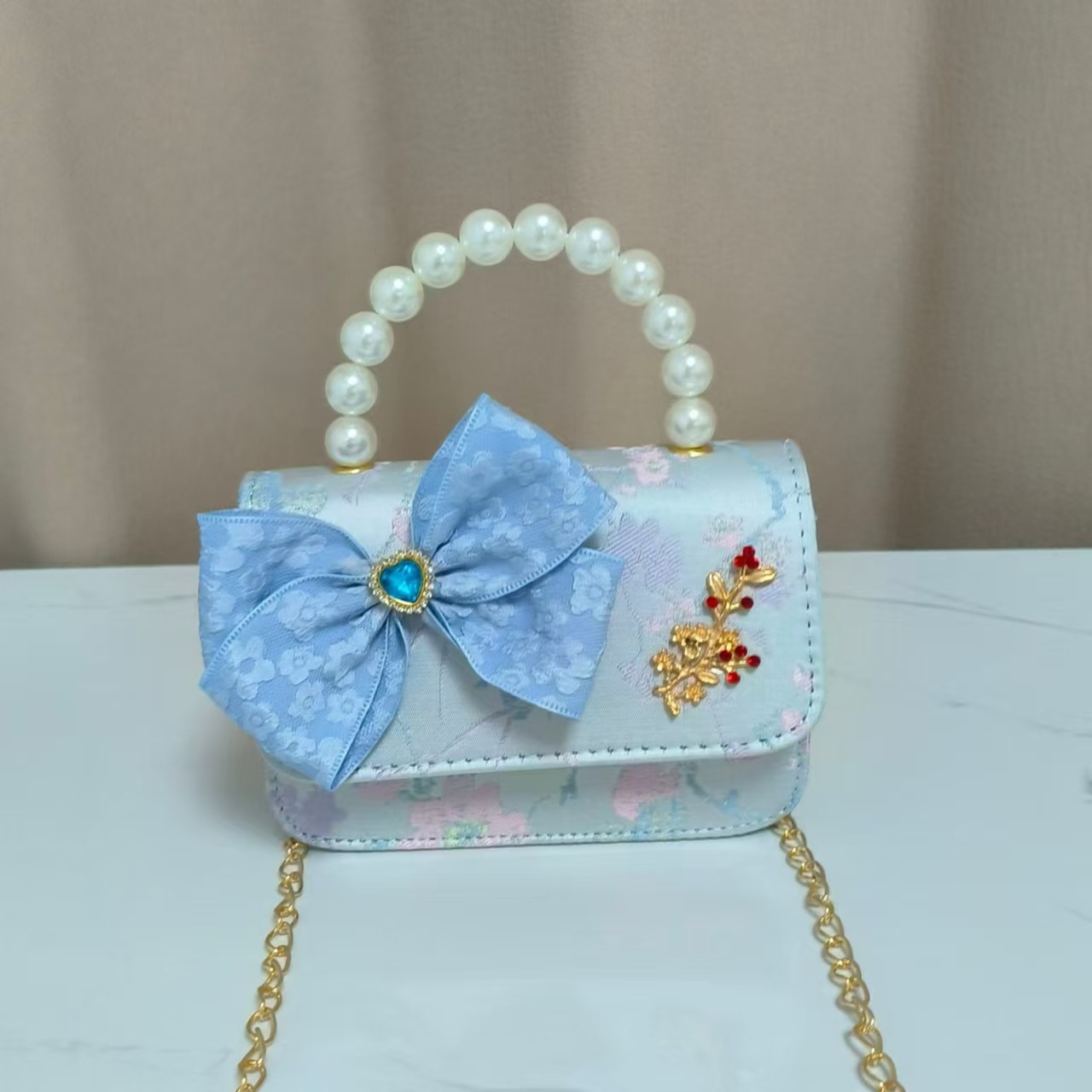 Bolso infantil nuevo bolso de hombro de niñas lindos bolsos de perlas de princesa arco de mariposa estilo nacional bolso de mochila pequeña bolsa