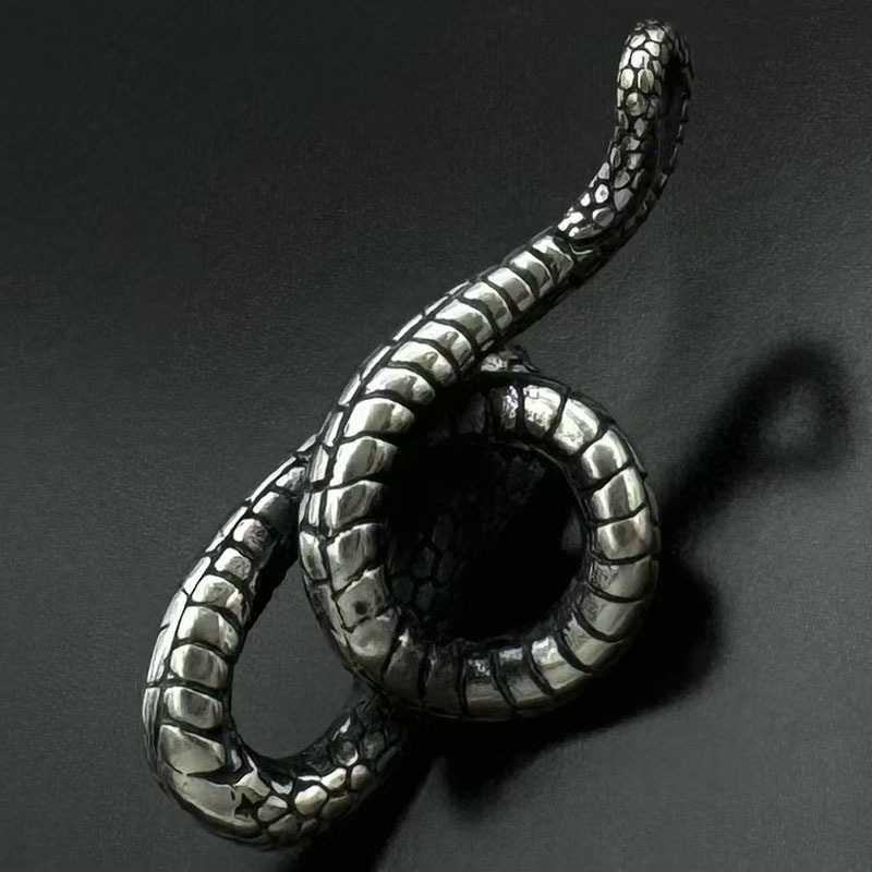 Another angle showing the intricate scales and the red stone