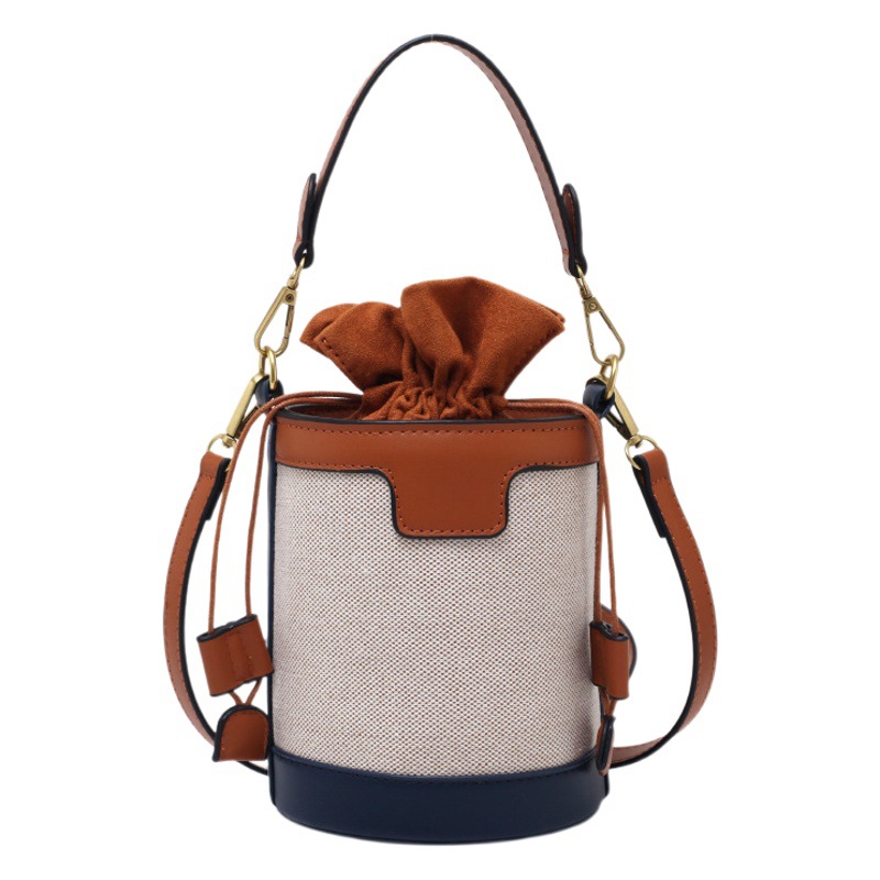 Bolso tipo cubo para mujer, nuevo estilo coreano 2026, bolso de hombro cilíndrico, bandolera retro de lona con bloques de color, a la moda