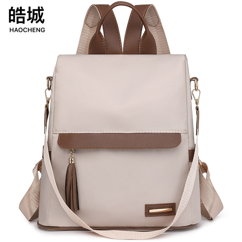 Comercio exterior nueva dama casual nailon mochila antirrobo moda borla color de contraste mochila de viaje de gran capacidad al por mayor