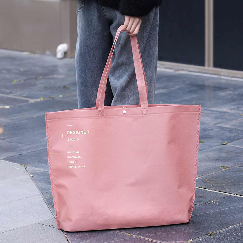 Bolso de mano no tejido de gran capacidad personalizado LOGO engrosado ropa de mujer protección ambiental bolsa de publicidad bolsa de compras de la tienda de ropa