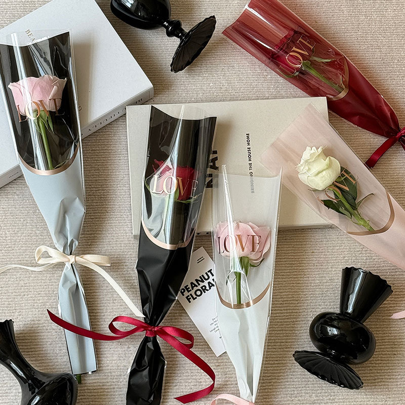 Huaxi LOVE estampado bolsas de flores bolsas de flores rosa bolsas de vidrio transparente papel de embalaje de flores OPP