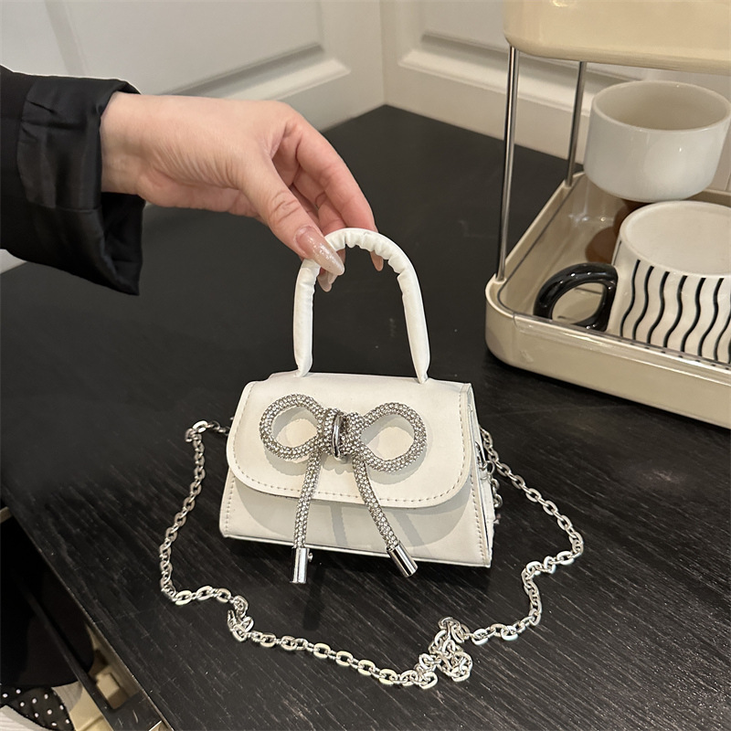 Bowknot Fashion versión coreana de estilo occidental pequeño bolso cuadrado bolso femenino 2025 verano nuevo bolso de cadena de viaje salvaje mujer