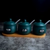Three dark green drum-shaped wooden seat set
