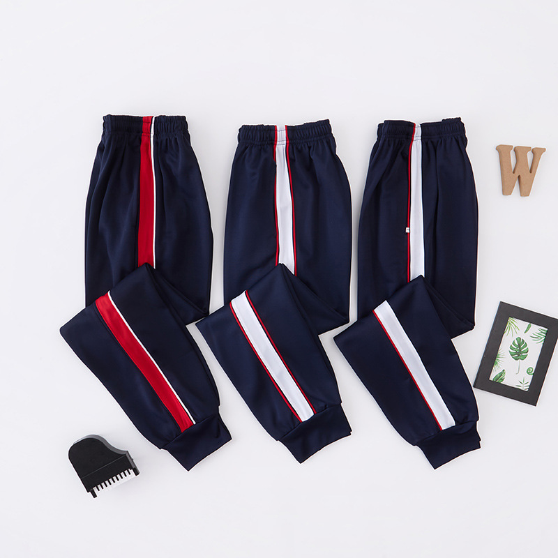 Dark Blue School Uniform Pants with White Thin Stripes and a Wide Red Stripe, Jogger Style, Loose Fit, Suitable for Male and Female Students, Spring/Summer Model Dark Blue School Uniform Pants with White Thin Stripes and a Wide Red Stripe, Jogger Style, Loose Fit, Suitable for Male and Female Students, Spring/Summer Model