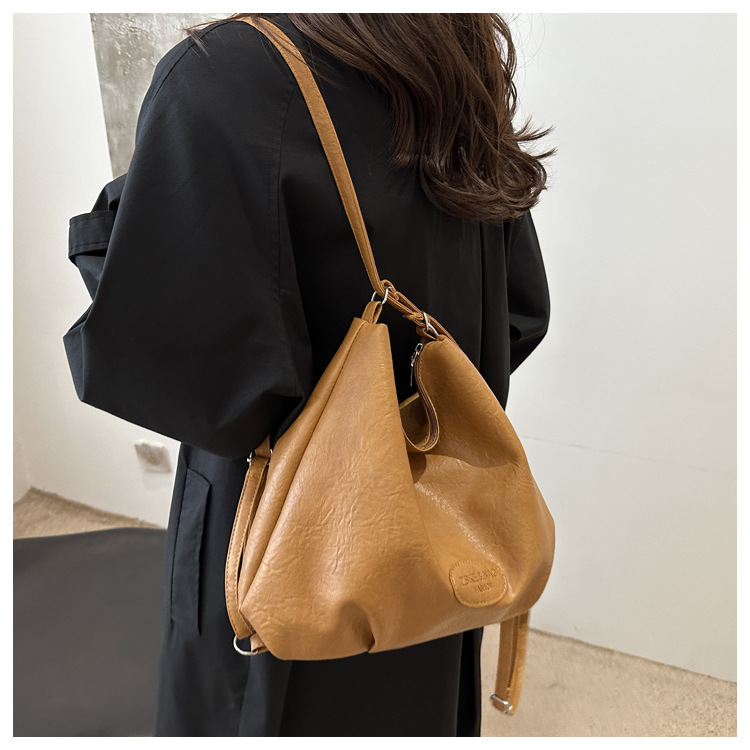 The 2024 new pleated tote bag is a large-capacity casual and fashionable backpack for women, featuring multi-functional texture and a single-shoulder crossbody bag undefined