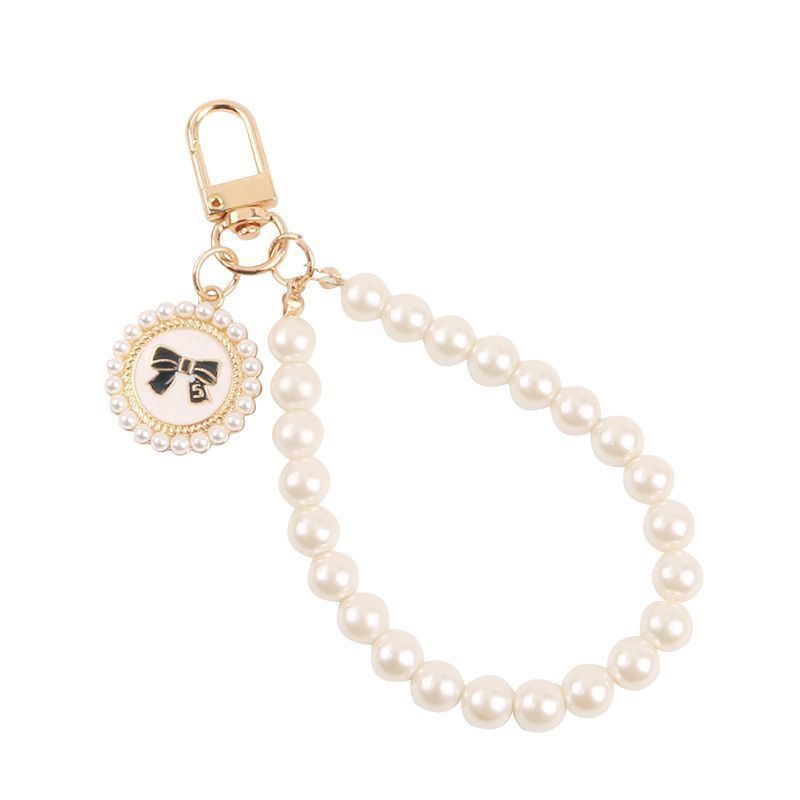 Cadena de perlas caja de teléfono móvil pequeña cadena de viento de fragancia nueva pulsera corta muñeca delicada colgante de mujer portátil