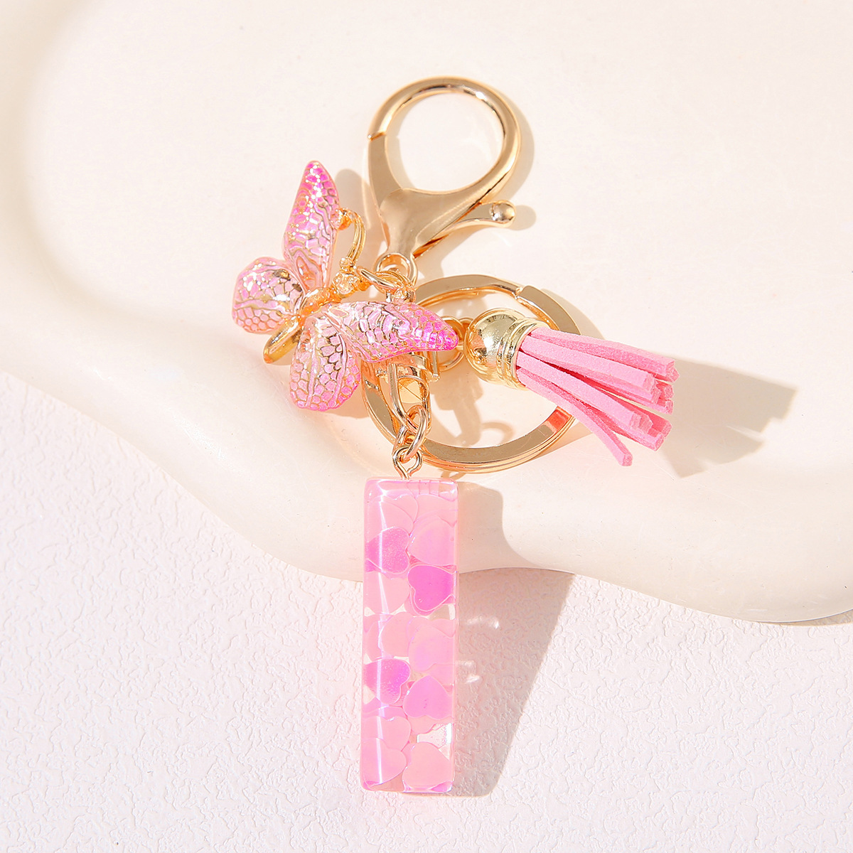 Nuevo rosa damas letras A-Z llavero de goteo de goma sequilla amor letras bordas mariposa llavero transfronterizo