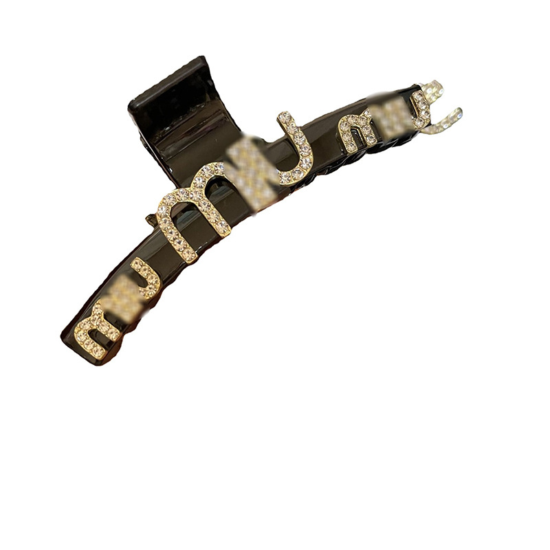 Elegant black hairgrip with letters