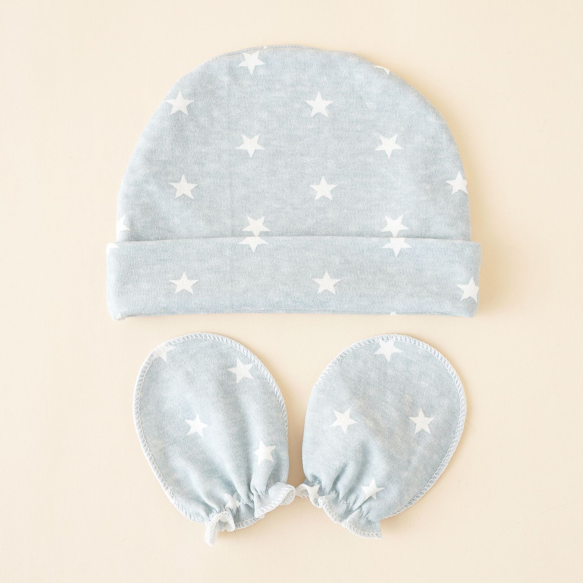 Sombrero de bebé primavera y otoño invierno 0-3-6 meses tamaño súper pequeño conjunto de dos piezas patrón de estrella bolsa de recién nacido guantes tapa del neumático