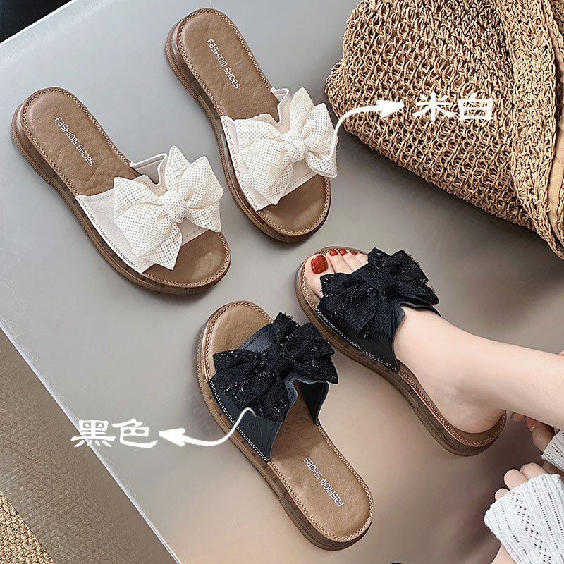 Cowhide 버전 ~ 활 슬리퍼 여성의 여름 의상 인터넷 축하 2025 새로운 여성 패션 플랫 비치 신발 샌들
