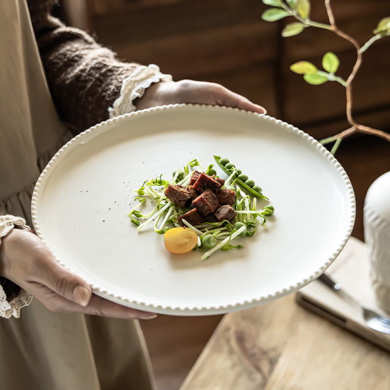 Platos de cerámica de color sólido al por mayor platos de mesa de alta calidad platos redondos de cuentas platos caseros platos de filete de comida occidental