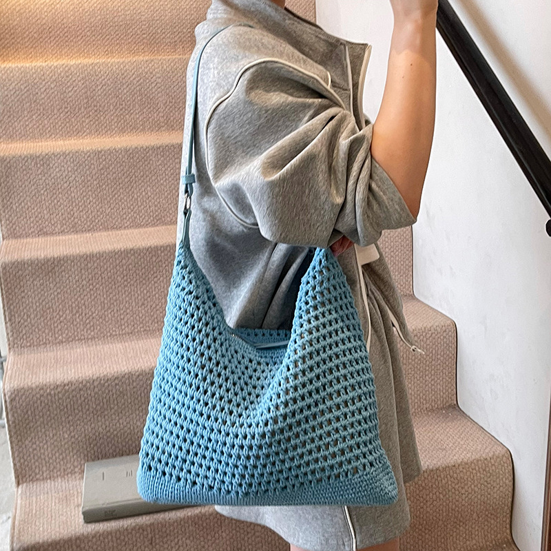 Venta caliente de verano nuevo producto bolsa tejida hueca para mujer 2025 bolsa de playa estilo vacaciones bolsa de paja de gran capacidad bolsa de cubo