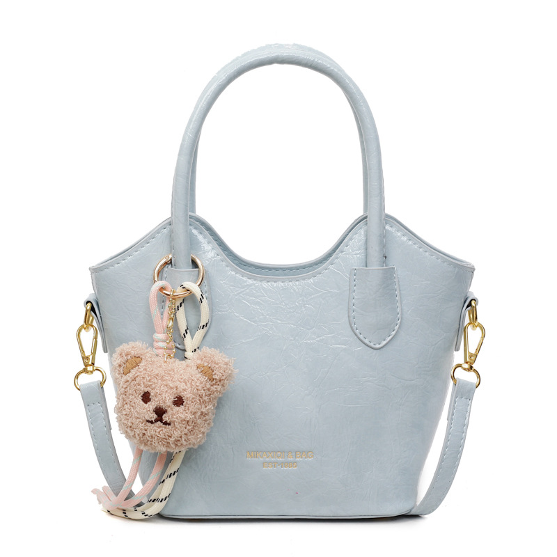 Versión coreana del bolso de cubo de mano casual simple para mujer 2025 nuevo bolso de hombro de viajero de todo fósforo bolso de mensajero de tendencia de moda