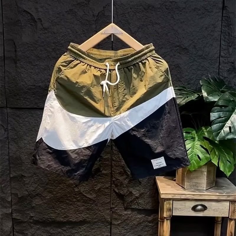 Pantaloncini estivi con etichetta di moda abbinati a colori casual larghi e versatili per pantaloncini da spiaggia sportivi ad asciugatura rapida da uomo_voghion.com