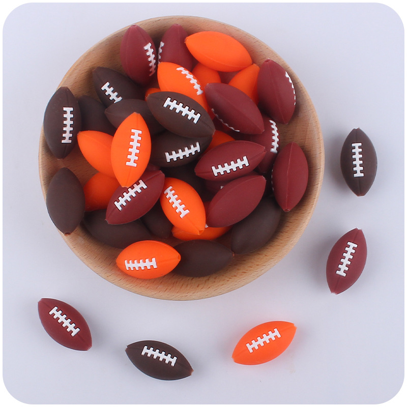 Creativo DIY suministros de bebé de dibujos animados de silicona rugby mordedura de bebé mordedura molar cadena de chupete accesorios