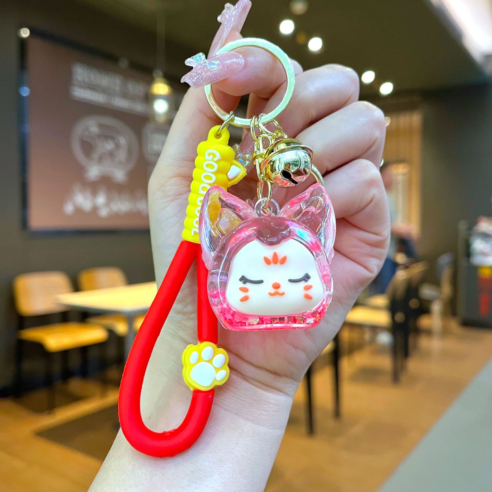 Aceite de gato garra arenas movedizas llavero lindo dibujos animados cadena colgante captura muñeca máquina agarrar pequeño regalo al por mayor