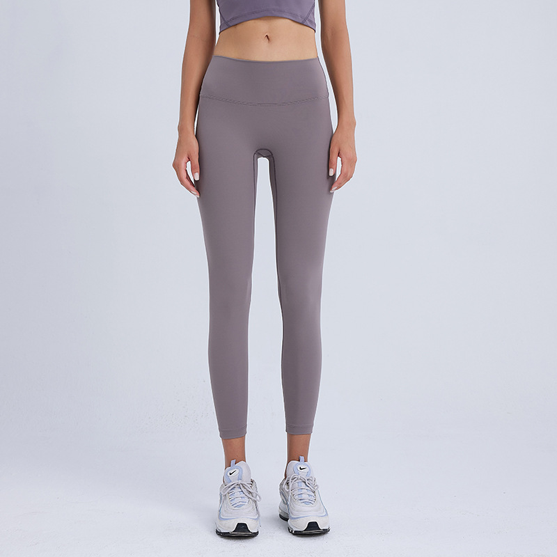 気まずい線の9分のズボンの高弾力のヨガのズボンのレギンスの女性の美のヒップのズボンのやせている腰はやせている運動のタイツを現します