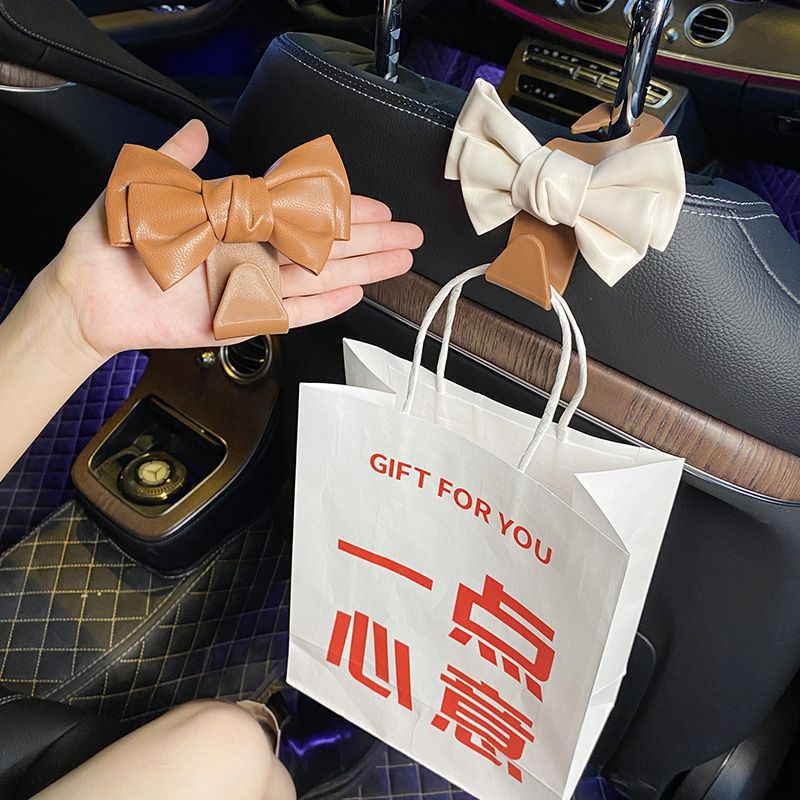 Garganto de automóvil Garganto de respaldo de silla Red cuero lindo arco multifuncional coche pequeño gancho de plástico