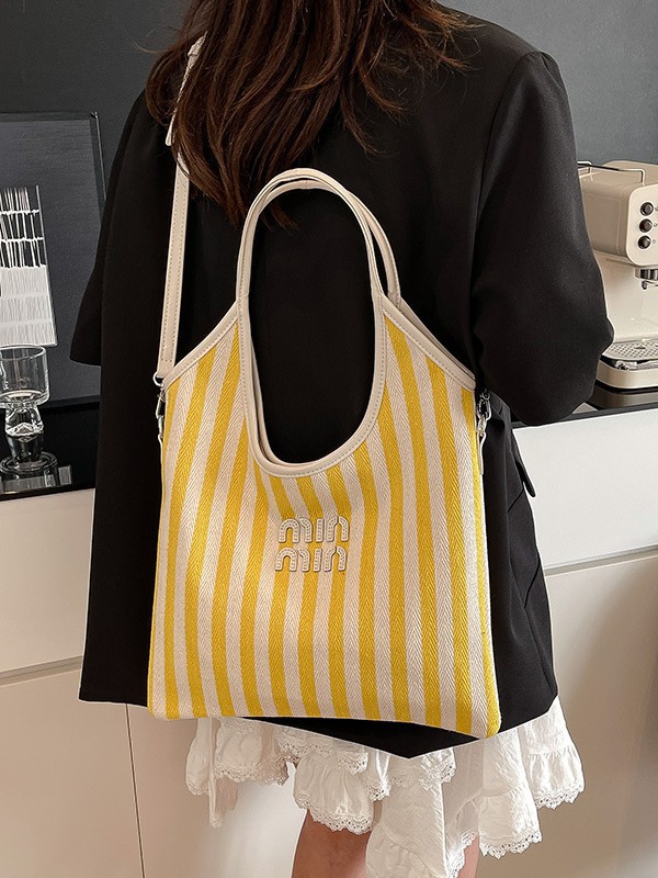 Bolsa de hombro a rayas de lona 2026 nueva sensación de lujo ligera casual diaria gran capacidad mochila