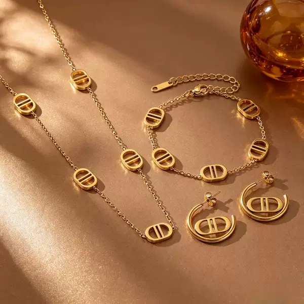 Popular European and American light luxury titanium steel 18K gold-plated double D hollow oval necklace, bracelet, and earrings three-piece set for women