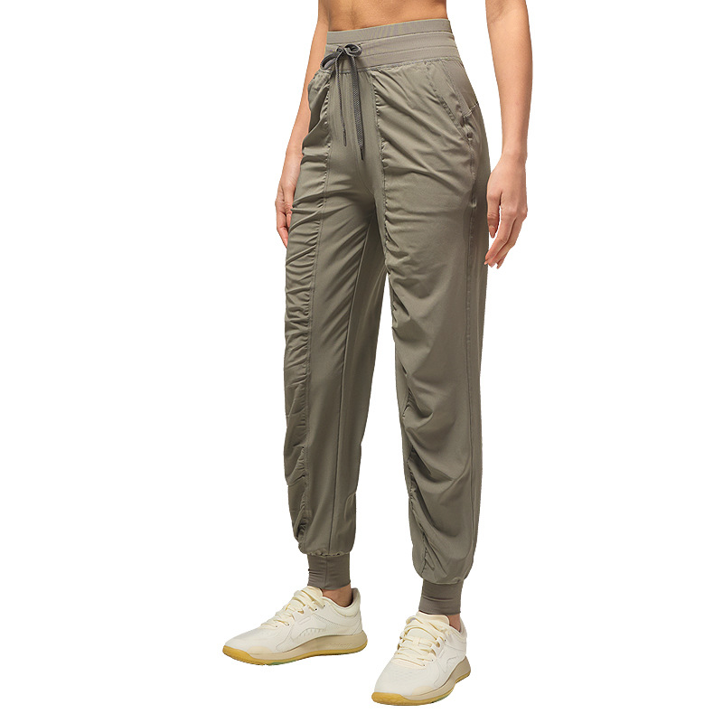 Pantalones deportivos casuales sueltos de mujer plegados para correr pantalones de yoga de nueve puntos de bolsillo secado rápido pantalones de pies transpirables