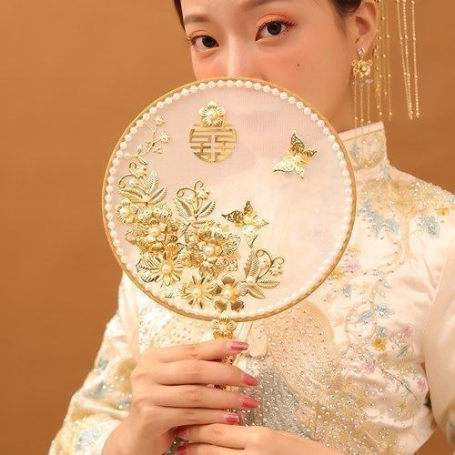 中国式の結婚式の秀禾の顔の団扇の新婦は結婚して花の古風を持って結婚します。|undefined